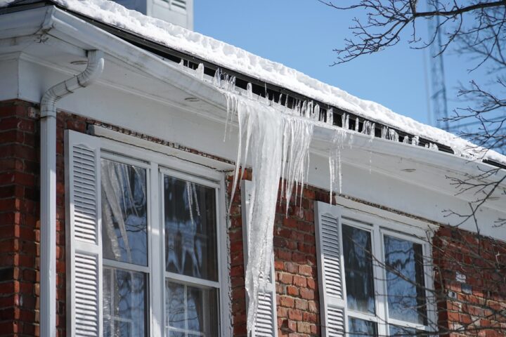 Ottawa house with icicles and damaged soffit caused by poor attic insulation.
